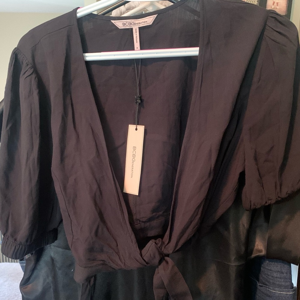 Black, BCBG top- tie with thread-thru to wrap. Adorable! New, with tags!